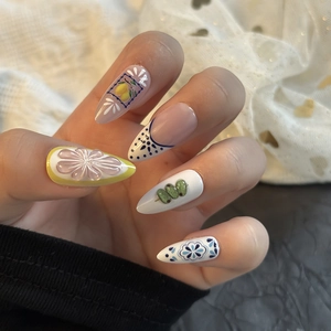 Blue and white press-on nails with 3D floral accents and Mediterranean lemon motifs