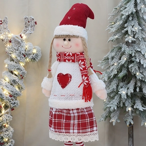 Knitted Christmas girl doll with red pointed hat and snowflake scarf for festive decor