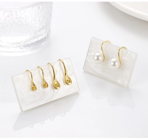 Macro shot of gold S925 sterling silver ear hooks and pearl earring DIY components