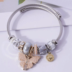 DIY stainless steel charm bracelet featuring pearl butterfly and heart pendants