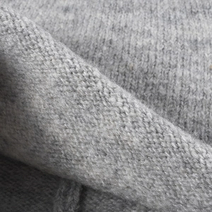 Thick grey knit beanie hat made of warm wool fabric for autumn and winter fashion