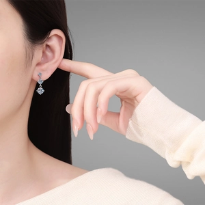 Elegant S925 silver earrings with three vertical Moissanite diamonds on a model