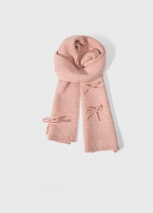 Close-up of pink knit scarf featuring dual 3D ribbon bows and ribbed wool texture
