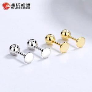 Detailed macro view of S925 sterling silver ball stud earrings in gold and silver finishes