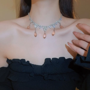 Detail of silver choker with zircon pavé and five drop-shaped pink crystals on model