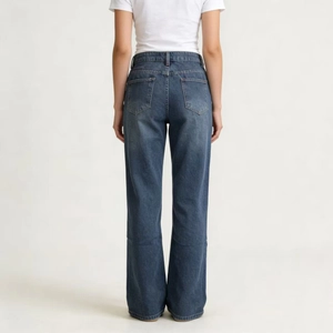 Detail view of the back pockets and tailored fit of vintage dark blue wide leg jeans