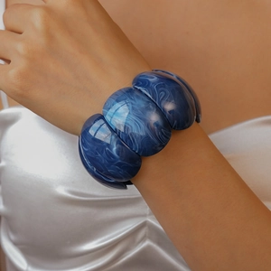 Macro detail of dark blue marble pattern resin cuff bracelet with polished finish