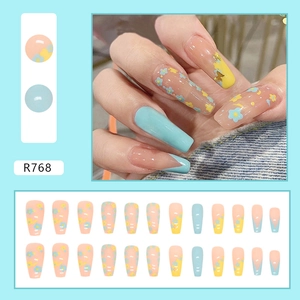 Detail view of R768 press-on nails set featuring floral patterns and butterfly sequins