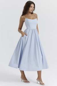 Close-up of the light blue midi dress showing pleat details and practical side pockets