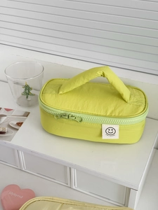 Minimalist green smiling face storage bag with handle and smileday print on white stand