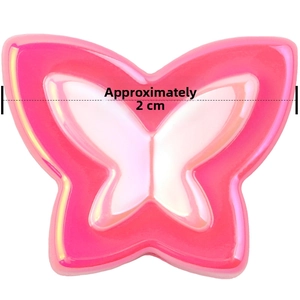 Macro detail of a 2cm pink iridescent resin butterfly bead for DIY hair accessory making