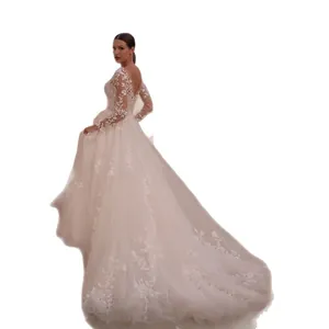 Elegant long-sleeved lace wedding dress with deep V-back and long trailing mesh skirt