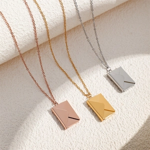 Three minimalist stainless steel envelope pendant necklaces in rose gold, gold, and silver