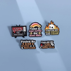 Set of five creative metal enamel pins featuring iced coffee slogans on blue background
