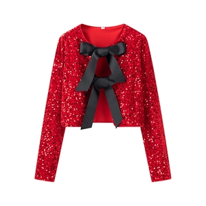 Sparkly red sequin bolero with black satin bows on white background