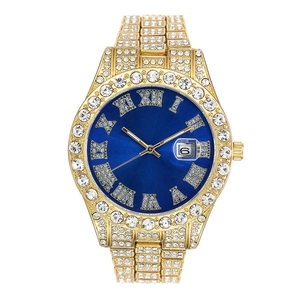 Close-up of luxury gold iced-out watch with blue dial and roman numeral markers