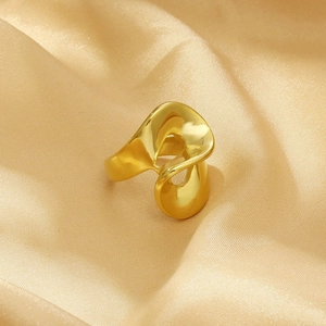 Macro view of geometric 18K gold plated titanium steel ring on champagne silk fabric