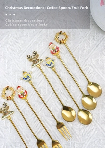 Detailed view of gold stainless steel Christmas spoons and forks with cute festive motifs
