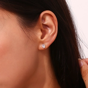 Close-up of a model wearing a 18K gold plated marquise zircon stud earring