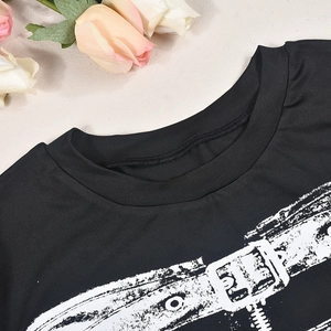 Detail shot of black long sleeve top featuring stylish white graphic print and crew neck