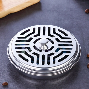 Top view of circular stainless steel incense burner with geometric hollow carved lid