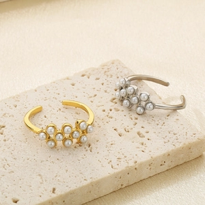 Elegant gold and silver titanium rings with clusters of white pearls on stone
