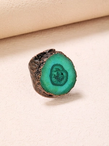 Macro view of vintage bronze ring featuring a natural green agate stone and hammered texture
