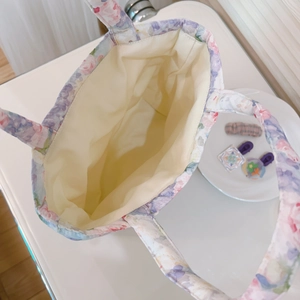 Detailed interior view of floral quilted tote bag with spacious compartment and soft cotton lining