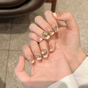Elegant maple leaf press-on nails with champagne rhinestones and amber marble texture