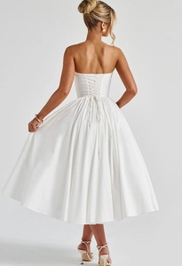 Detailed corset style lace-up back design on an elegant white strapless midi dress