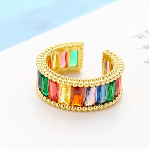 Detail of gold-plated open ring featuring multi-color rainbow baguette zircons and beaded edges