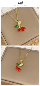 Detailed tile display of cherry pendant necklace with red cubic zirconia and gold chain