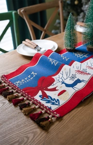 Detailed weave of Christmas table runner with reindeer motifs and Merry Christmas text