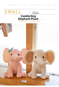 Pink and white plush elephants sitting on a wooden windowsill with soft natural lighting