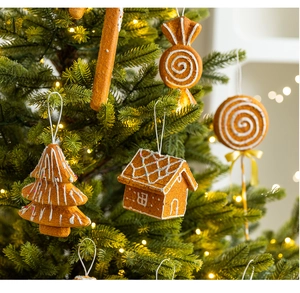 Close-up of gingerbread style ornaments with white icing texture on a Christmas tree