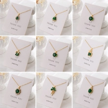 Detailed grid of gold necklaces featuring various green zircon and emerald pendants