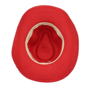 Macro inside view of a red straw sun hat showing the breathable weave texture