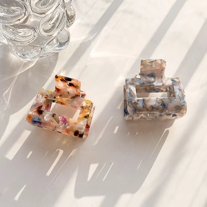 Square acetate floral hair claw clips set with elegant marble patterns in natural light