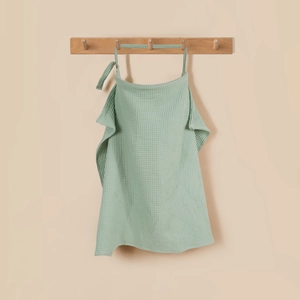 Detail of light green cotton waffle nursing cover with adjustable neck strap on hook