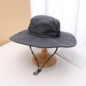 Detail of dark grey sun hat with metal air vents and adjustable chin strap