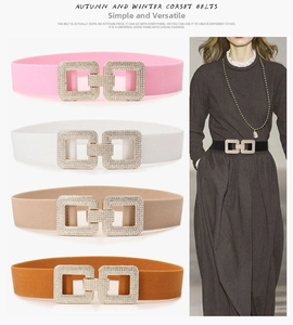 Detail of four colorful elastic waist belts with rhinestone double-square buckles for women