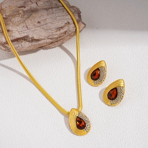 Retro gold snake chain necklace and red teardrop earrings set with sparkling rhinestones