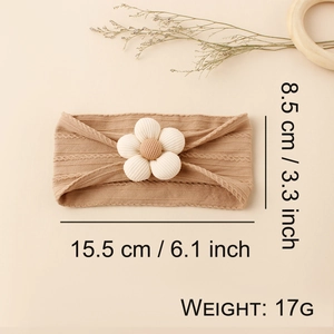 Brown nylon knit baby headband with white flower detail and texture dimensions