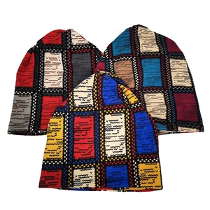 Three knitted beanie hats with colorful geometric square patterns for autumn and winter