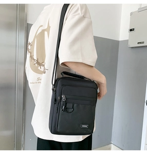 Detail view of the black multi-functional crossbody bag with adjustable wide shoulder strap
