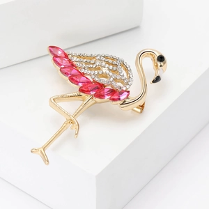 Close-up of golden flamingo brooch with pink marquise crystals and rhinestones