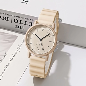 Detail of cream round quartz watch with wavy silicone strap on minimalist white steps