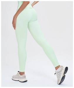 Close-up of high-waisted seamless mint green yoga pants showing peach butt lifting effect