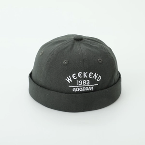 Detailed embroidery of 'WEEKEND' lettering on a dark grey cotton kids' docker cap