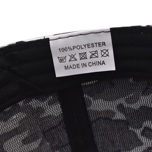 Close-up of the mesh polyester interior and care label on the camouflage baseball cap